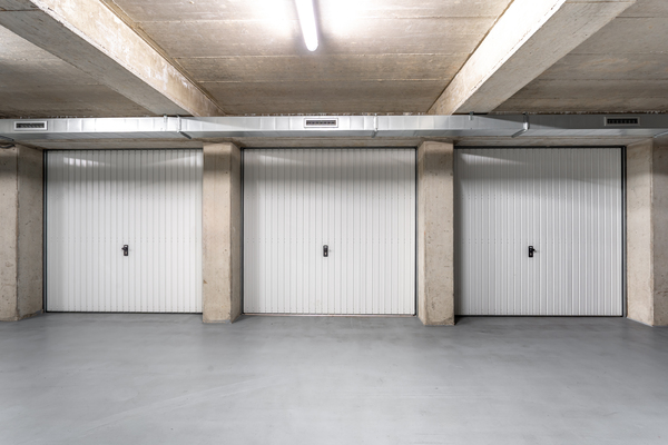 Closed white garage doors with epoxy floor patching, ideal for garage organizers home depot or ikea garage storage shelves setups.