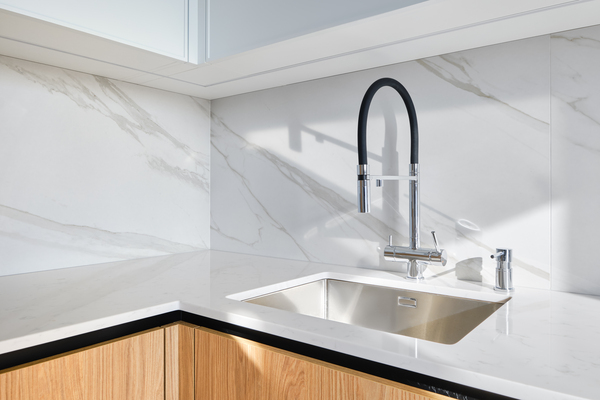 Modern kitchen design luxury with sleek sink, porcelain slab backsplash, and home depot kitchen countertop.