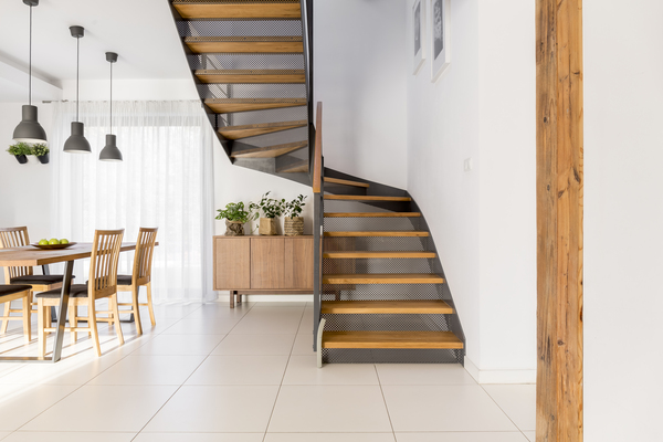 Modern home interior with steel stair stringer channel and wooden stair treads and risers.