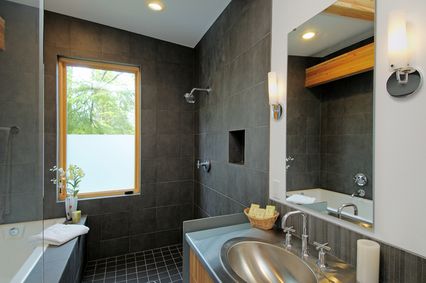 Contemporary bathroom featuring sleek designer fixtures, dark tile, and built-in shower – designer bath fixtures