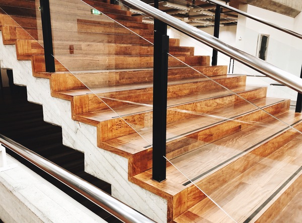 stair stringer with wood finish and glass railing