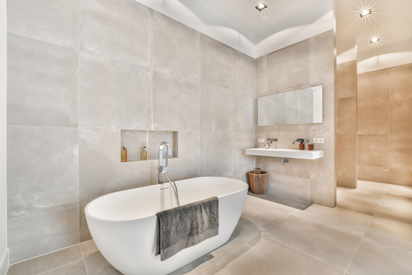 Elegant bathroom showcasing a freestanding tub, neutral tile walls, and sleek decoration of bathrooms for a spa-like retreat