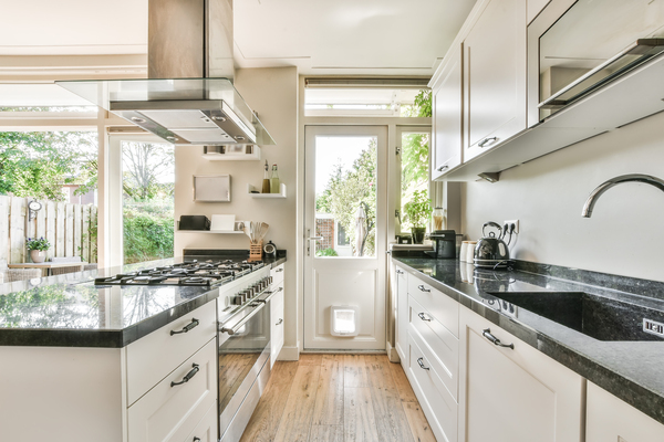 Bright kitchen showcasing top kitchen remodel ideas with black countertops