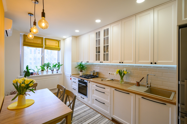 Contemporary kitchen design featuring wood countertops, pendant lighting, and tulip decor, perfect for lowe's home goods sofi kitchen remodeling ideas.