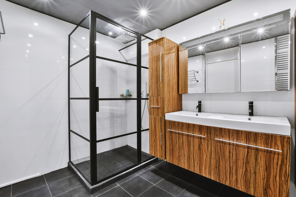Elegant bathroom design with wood cabinetry and framed shower, showcasing design bathroom remodel ideas and bathrooms ideas design