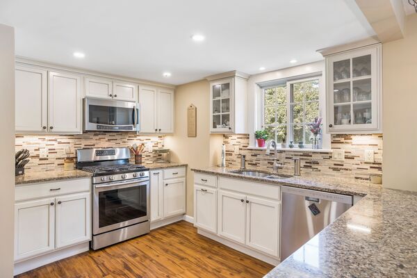 design of kitchen interior spacious kitchen with granite counters and tile backsplash Stylish kitchen with granite countertops and patterned backsplash for design of kitchen interior ideas