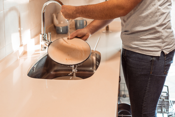 Man using a modern kitchen sink as part of free kitchen design visualizer