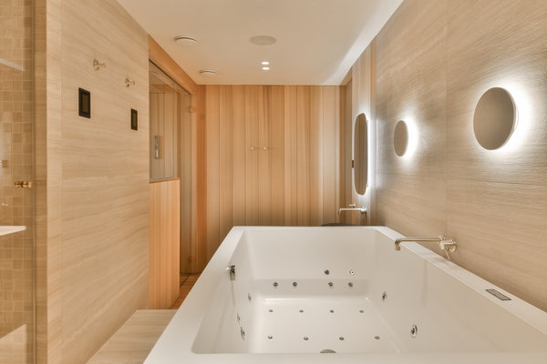 Minimalist jacuzzi bath remodel in a modern spa setting with wood walls and recessed lighting