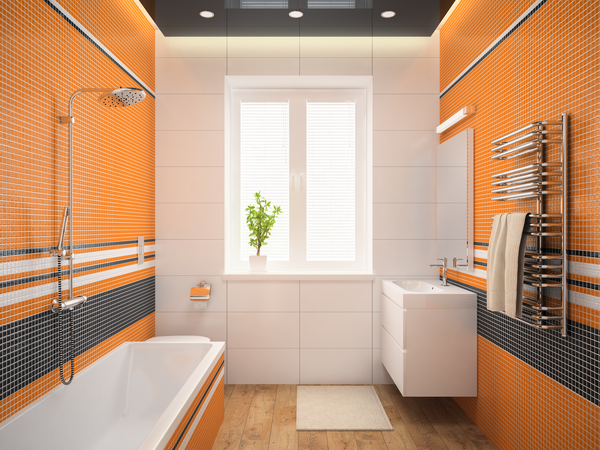 Bright bathroom with orange mosaic tiles and bath tub, showcasing bold bathroom tile ideas and shower wall panels.