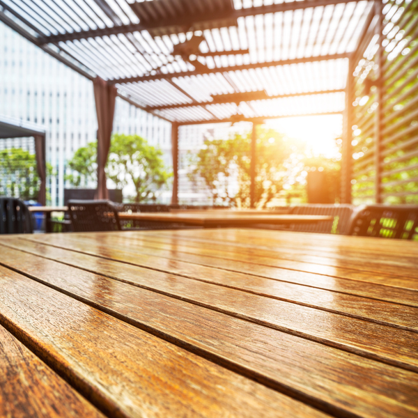 Outdoor Wooden Decking with City View Wooden deck surface under a shaded patio in an urban setting